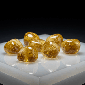 Polished tumbled Citrine quartz silicate trigonal on white matte background, healing crystal stones.