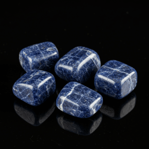 Polished tumbled Sodalite quartz silicate isometric on black matte background, elegant crystal stones.
