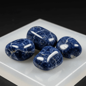 Polished tumbled Sodalite quartz silicate isometric on white matte background, healing crystal stones.
